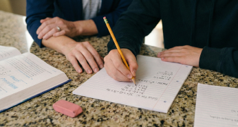 Child solving on paper